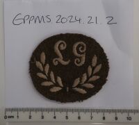 British Army Lewis Gunner (LG) cloth proficiency arm badge, 1914 - 1918, possibly belonged to donor's father in law Albert Clare (see 2024.21.5)